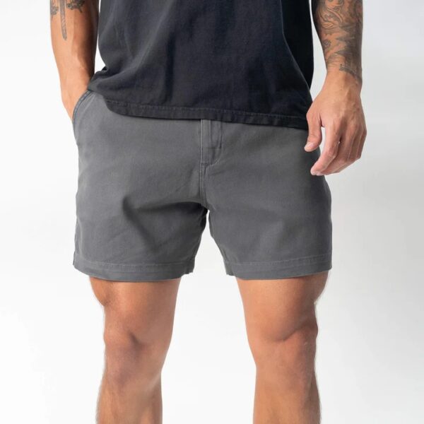 Man wearing charcoal grey casual shorts with front pockets and a black t-shirt, standing against a white background.