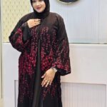 Woman wearing a black Dubai Imported Original Farasha Borka with striking red floral embroidery.