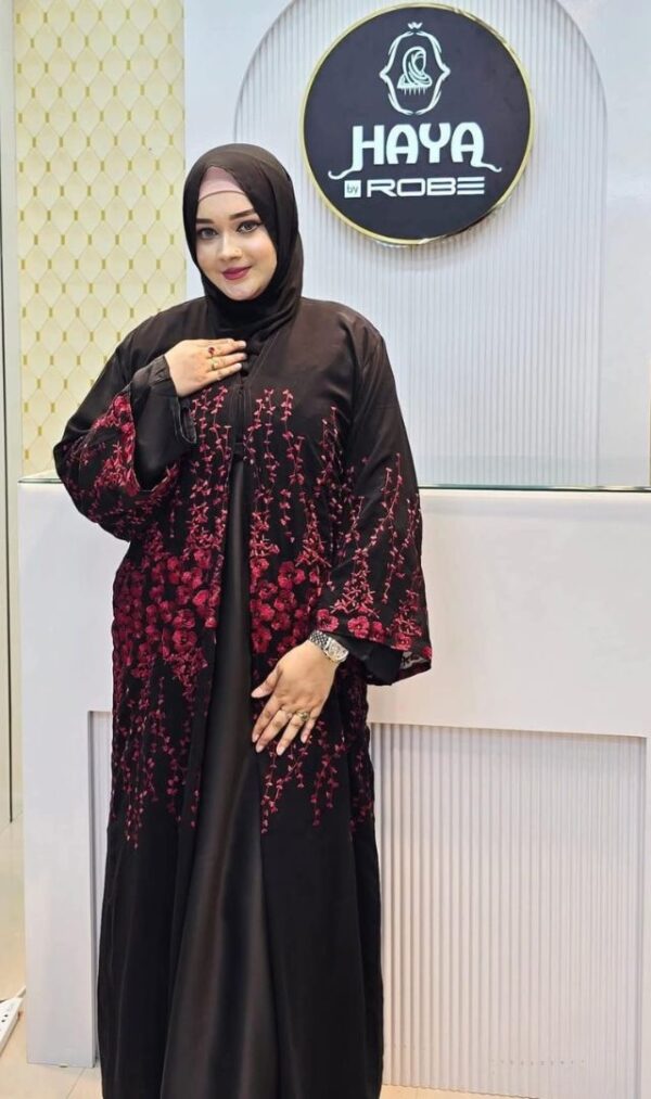 Woman wearing a black Dubai Imported Original Farasha Borka with striking red floral embroidery.