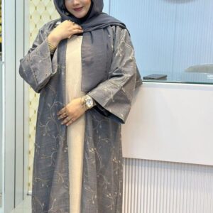 Woman wearing a stylish grey Lemas Cotton Borka with delicate embroidery, posing at the Hayah by Robe store.