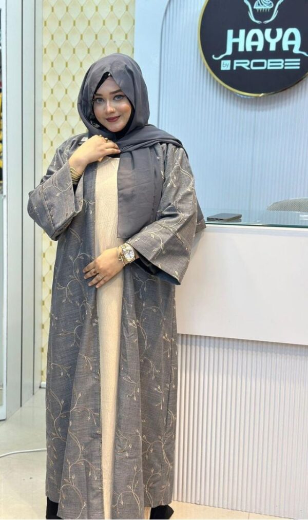 Woman wearing a stylish grey Lemas Cotton Borka with delicate embroidery, posing at the Hayah by Robe store.