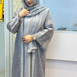 Woman wearing a Nida Boutiques Original Borka in grey with silver embroidered detailing, styled with a matching hijab at Hayah by Robe.