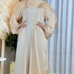 Woman wearing an elegant cream-colored Dubai Imported Koti Borka with intricate embroidery and a matching hijab.