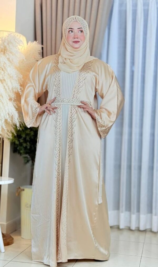 Woman wearing an elegant cream-colored Dubai Imported Koti Borka with intricate embroidery and a matching hijab.